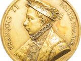 an image of a gold medal with a portrait of a man wearing a hat