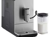 an image of a coffee machine with a glass of milk next to it