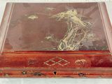 a wooden box with a picture of a dragon on it