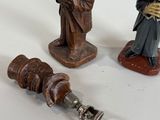three figurines that are next to each other on a table