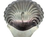 a silver shell shaped cake pan on a white background