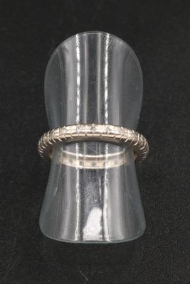 a close up of a silver ring with a rope around it