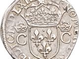 a silver coin with a crown on top of it