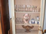 a cabinet that has a bunch of glasses on top of it