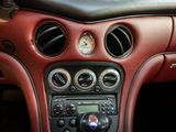 a dashboard of a car with various gauges and controls