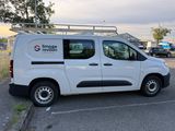 the white van is parked in the parking lot with its roof open