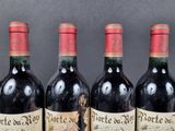 three bottles of red wine are lined up on a table