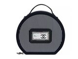 black and white striped bag with a chanel logo on it