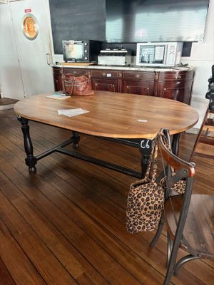 a wooden table with a bag on it in a room