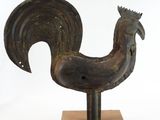 statue of a rooster on a wooden base on a white background