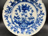 a blue and white plate with flowers on it