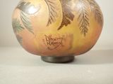 a vase with a design on it sitting on a table