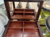 a wooden box with a glass top on a glass table