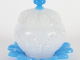 a close up of a white and blue glass bowl on a white surface