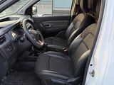 the interior of a white van with black leather seats and a steering wheel