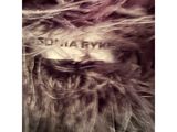 a close up of a furry animal with a tag on it