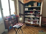 a room with a closet full of clothes and a table with a lamp