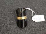a black and gold ring with a tag on it