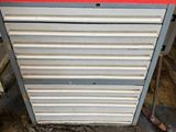 a red and silver tool cabinet in a garage