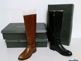 a pair of boots sitting next to a box of books
