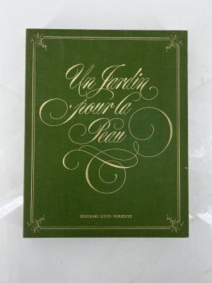 a green book sitting on top of a white table