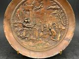 an old copper plate with an image of a man and a woman in a garden