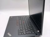 a laptop with a black keyboard on a white surface