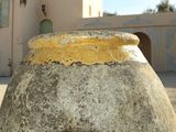 a large stone vase sitting in front of a building