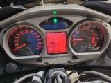 a close up of a motorcycle ' s dashboard with various gauges