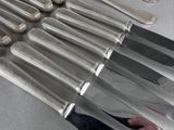 a lot of knives that are sitting on a table