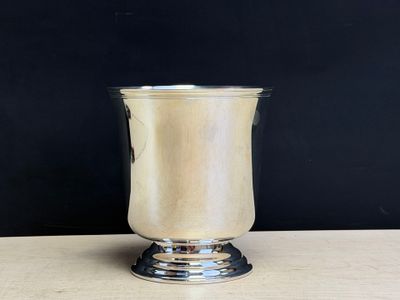 an image of a silver cup sitting on top of a wooden table