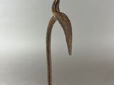 a close up of a metal stick with a bird on it