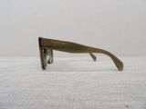 sunglasses on a table with a white wall in the background