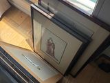 a picture of a cat sitting on a window sill next to a picture