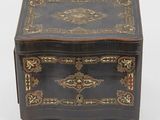 a black and gold box with a decorative design