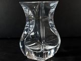 a clear glass vase sitting on a black surface