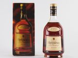 the bottle of hennesso is next to the box