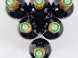 six bottles of wine are arranged in a circle on a white surface