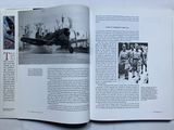an open book with a black and white photo of a fighter plane