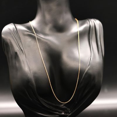 a black mannequin with a gold chain on it