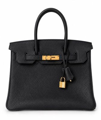 a black leather handbag with a lock on the handle