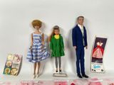 three dolls that are standing next to each other on a table