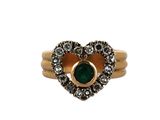 a close up of a gold ring with a green stone in the center