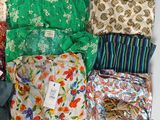 many different types of cloths laid out on a table