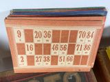 a stack of old bingo cards on top of a pile of old books