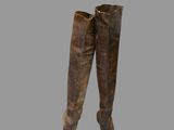 pair of brown leather boots sitting on top of a gray surface