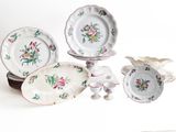 a lot of plates and bowls that are sitting on a table