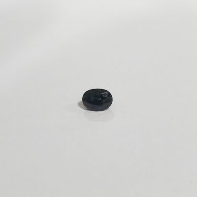 a close up of a small black object on a white surface