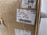 packaging of a box on a white table with a white chair in the background