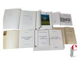 several open books on a white table with a red and black logo
